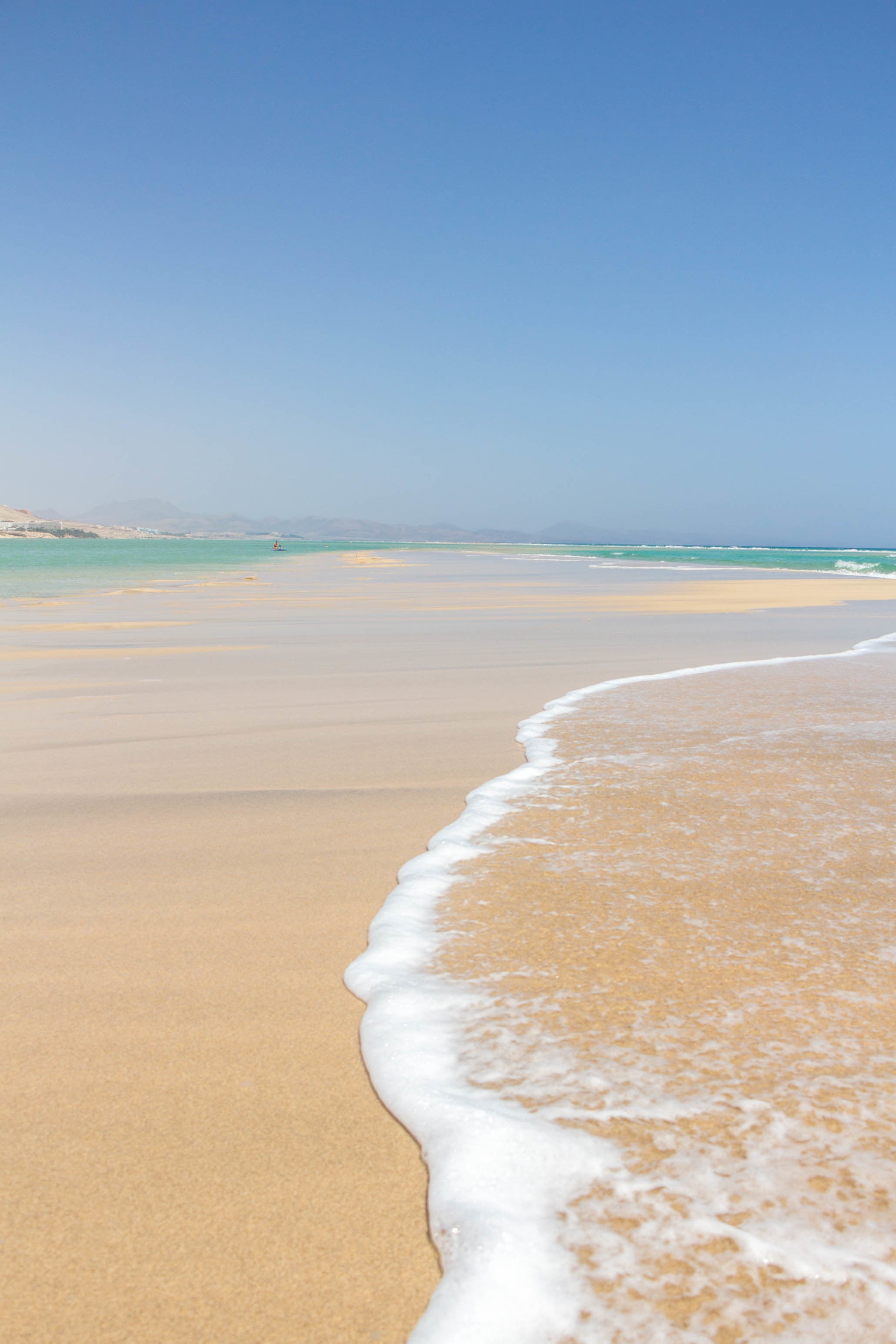 clear-blue-water-crawls-over-the-white-sandy-beach